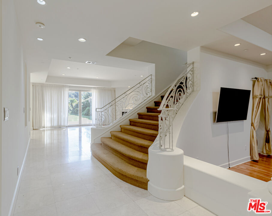 12626 Promontory Road Los Angeles, CA 90049 - Photo 12 of 34 a view of entryway and hall with wooden floor