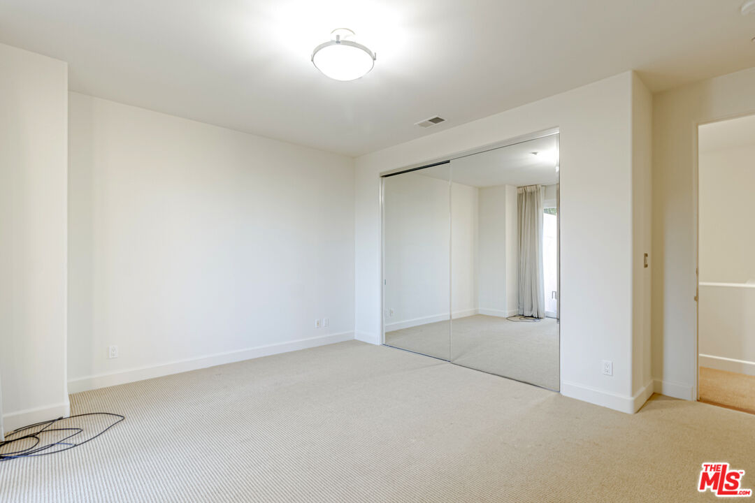 12626 Promontory Road Los Angeles, CA 90049 - Photo 16 of 34 an empty room with a empty space and windows