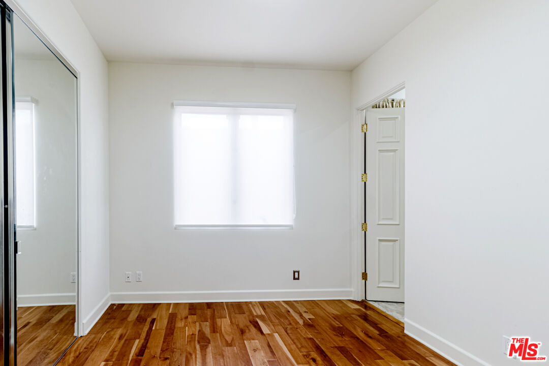 12626 Promontory Road Los Angeles, CA 90049 - Photo 18 of 34 a view of a room with wooden floor and a window