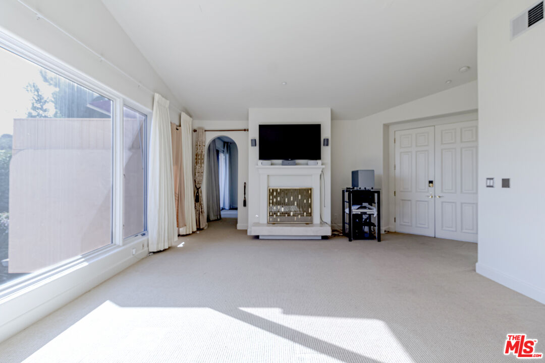 12626 Promontory Road Los Angeles, CA 90049 - Photo 19 of 34 a view of livingroom with furniture and a flat screen tv