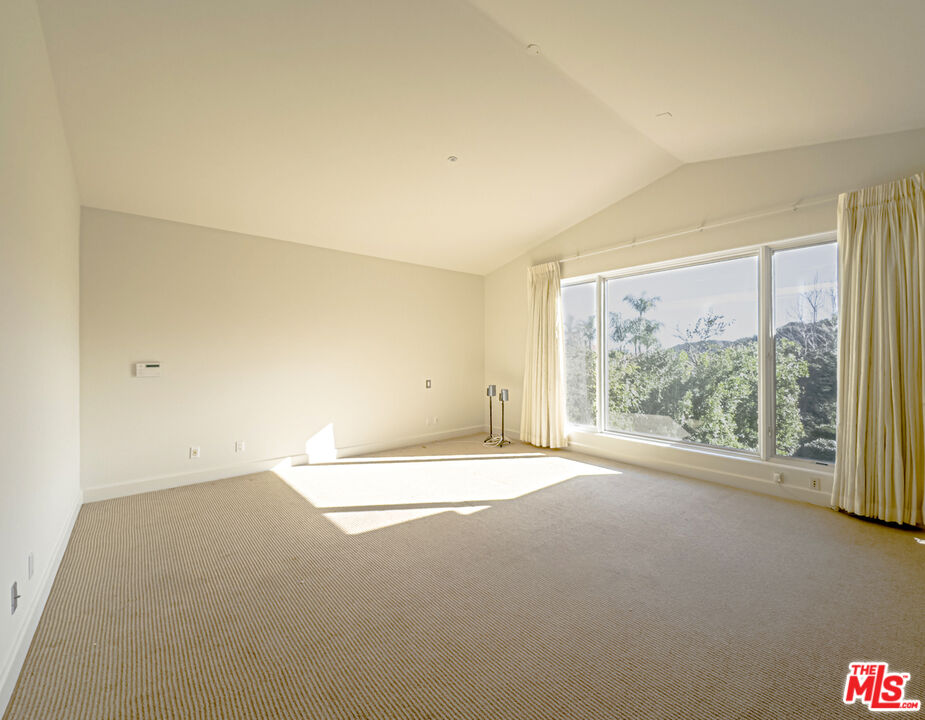 12626 Promontory Road Los Angeles, CA 90049 - Photo 20 of 34 a view of an empty room with a window