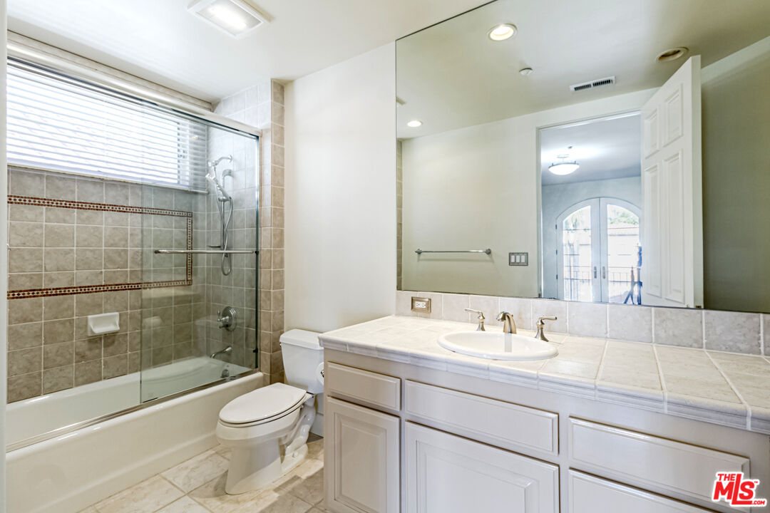 12626 Promontory Road Los Angeles, CA 90049 - Photo 25 of 34 a bathroom with a sink a toilet and shower