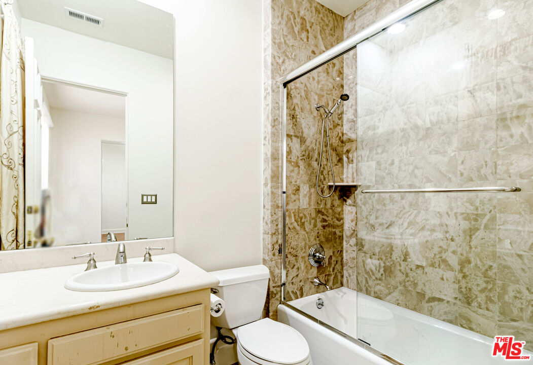 12626 Promontory Road Los Angeles, CA 90049 - Photo 26 of 34 a bathroom with a sink toilet and shower