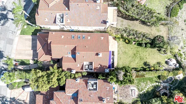 an aerial view of a house with a yard and garden