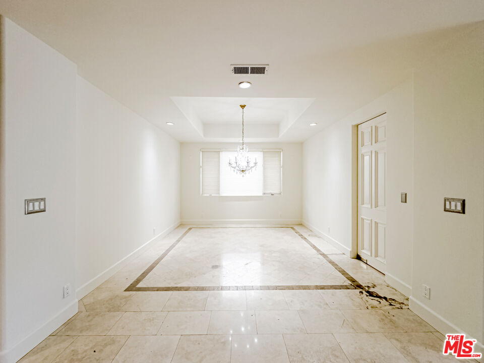 12626 Promontory Road Los Angeles, CA 90049 - Photo 10 of 34 an empty room with windows and fan