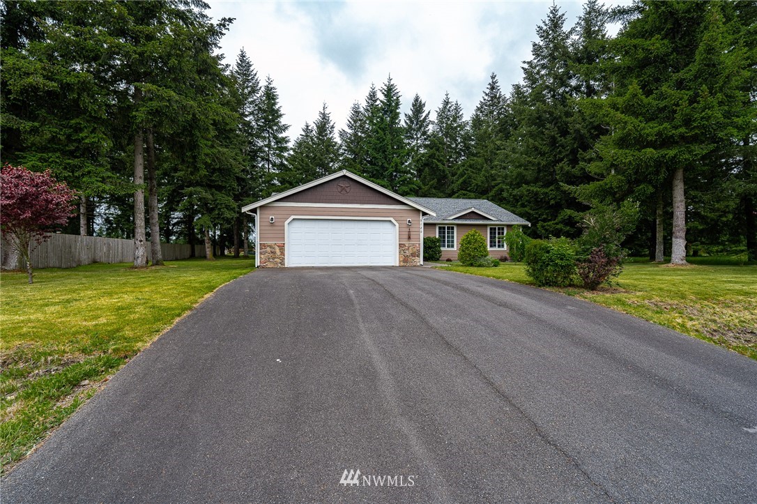 5120 180th Trail Southwest Rochester, WA 98579 - Photo 2 of 32 a front view of a house with a yard