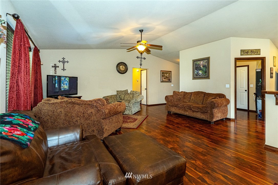 5120 180th Trail Southwest Rochester, WA 98579 - Photo 11 of 32 a living room with furniture and a chandelier