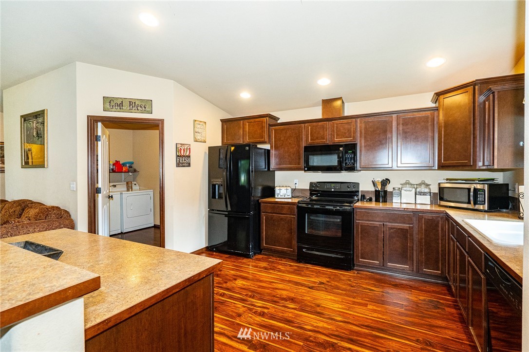 5120 180th Trail Southwest Rochester, WA 98579 - Photo 12 of 32 a kitchen with stainless steel appliances granite countertop a refrigerator stove and oven