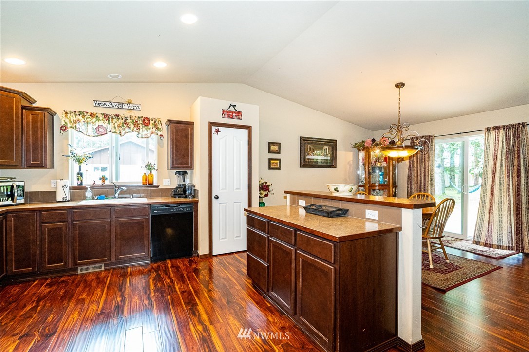 5120 180th Trail Southwest Rochester, WA 98579 - Photo 15 of 32 a kitchen with stainless steel appliances granite countertop a stove and a wooden floors