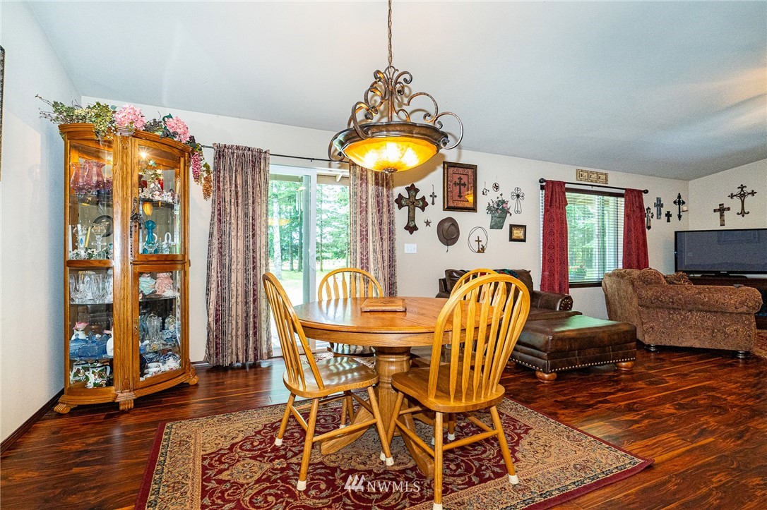 5120 180th Trail Southwest Rochester, WA 98579 - Photo 16 of 32 a dining room filled chandelier and wooden floor