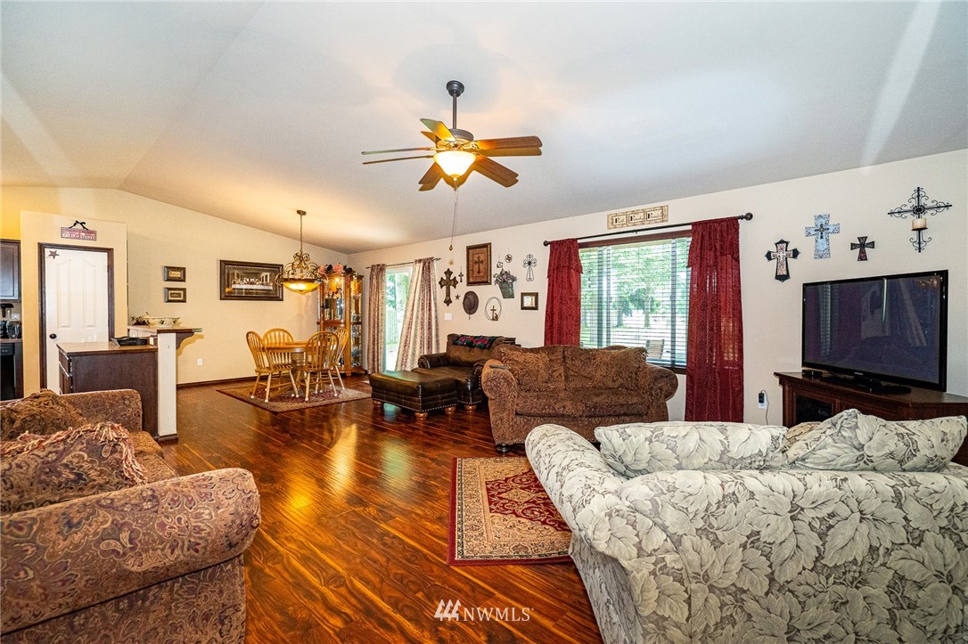 5120 180th Trail Southwest Rochester, WA 98579 - Photo 17 of 32 a living room with furniture a flat screen tv and wooden floor
