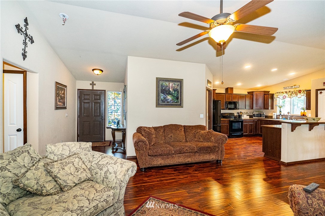 5120 180th Trail Southwest Rochester, WA 98579 - Photo 18 of 32 a living room with fireplace furniture and a wooden floor