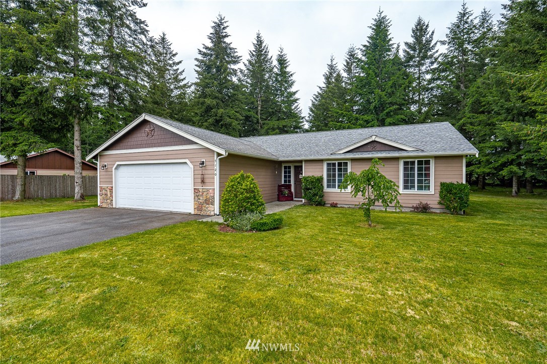 5120 180th Trail Southwest Rochester, WA 98579 - Photo 3 of 32 a front view of a house with a garden