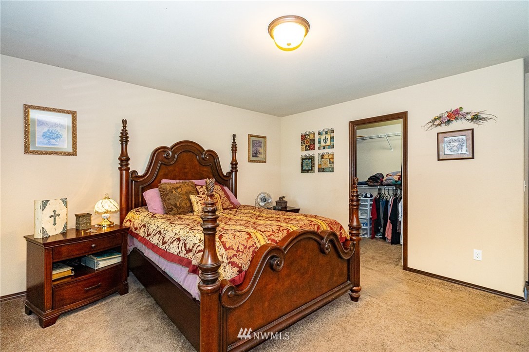 5120 180th Trail Southwest Rochester, WA 98579 - Photo 22 of 32 a bed sitting in a bedroom next to a window