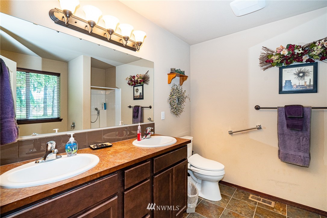 5120 180th Trail Southwest Rochester, WA 98579 - Photo 23 of 32 a bathroom with a double vanity sink toilet and a mirror