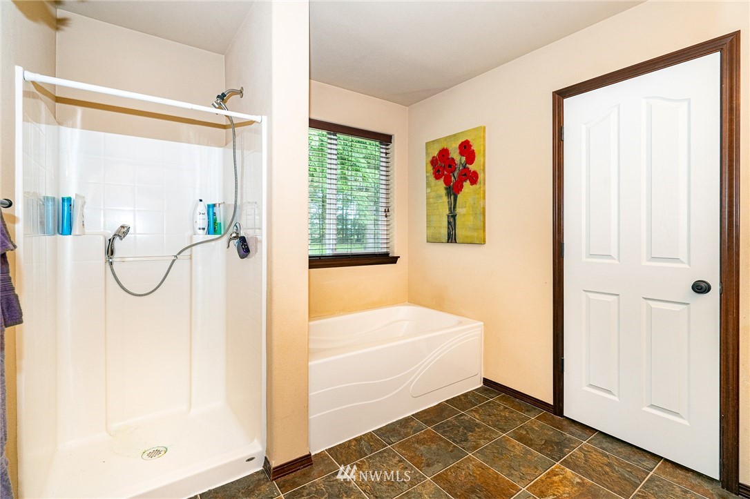 5120 180th Trail Southwest Rochester, WA 98579 - Photo 24 of 32 a bathroom with a tub and a shower