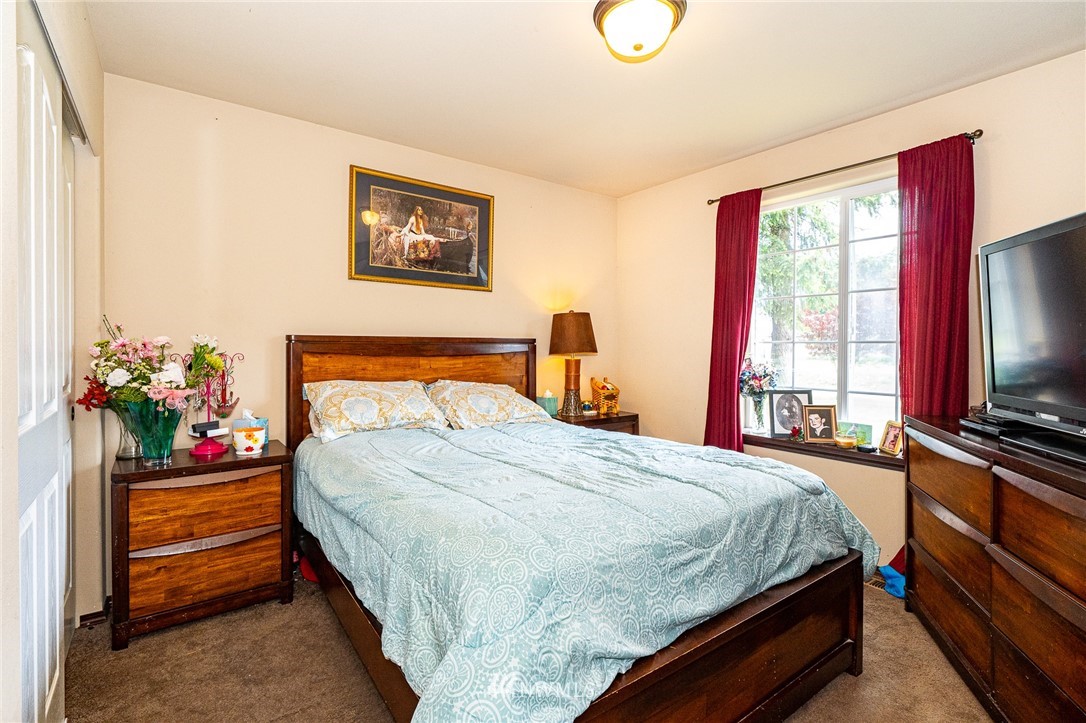 5120 180th Trail Southwest Rochester, WA 98579 - Photo 28 of 32 a bedroom with a bed and a flat screen tv