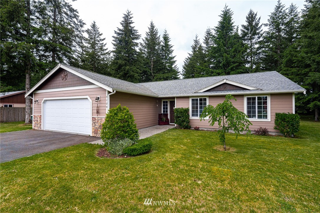 5120 180th Trail Southwest Rochester, WA 98579 - Photo 29 of 32 a front view of a house with a yard and garage