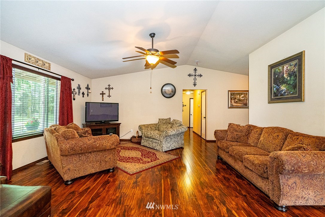 5120 180th Trail Southwest Rochester, WA 98579 - Photo 10 of 32 a living room with furniture a fireplace and a flat screen tv