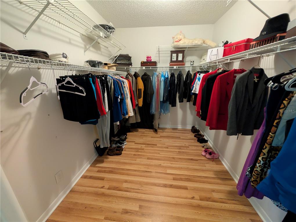 9897 Southwest 88th Court Road, Unit P Ocala, FL 34481 - Photo 19 of 35 a view of walk in closet with clothes and shoes