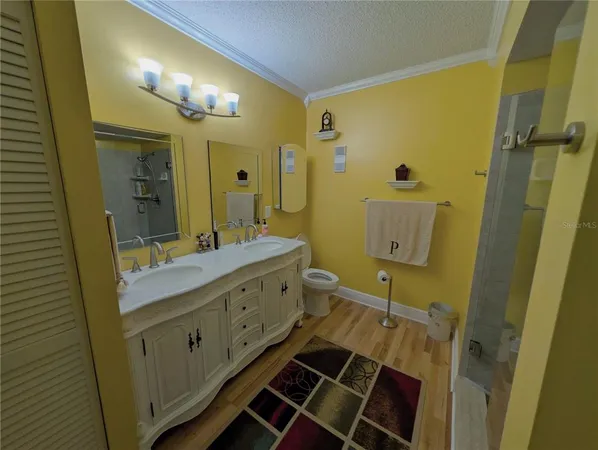 a bathroom with a double vanity sink mirror and shower