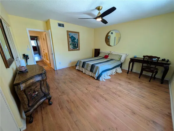 a bedroom with a bed and wooden floor