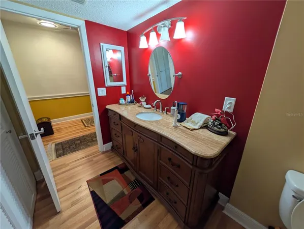 a bathroom with a sink mirror and vanity