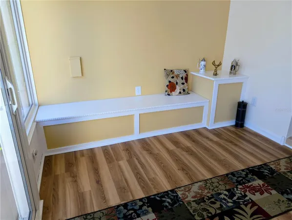 a living room with a couch wooden floor and a flat screen tv