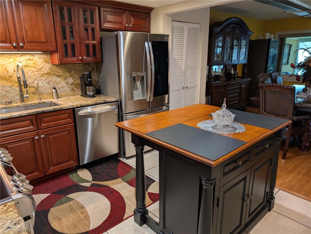 9897 Southwest 88th Court Road, Unit P Ocala, FL 34481 - Photo 5 of 35 a kitchen with stainless steel appliances a dining table and chairs
