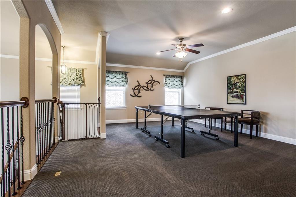 300 Rugby Lane McKinney, TX 75072 - Photo 17 of 25 Carpeted bonus room with a ceiling fan, recessed lighting, arched doorway, and wrought iron railing