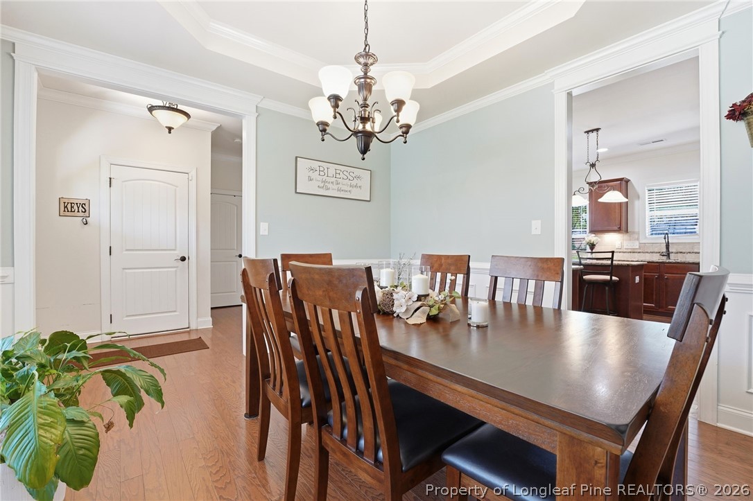 886 Micahs Way North Spring Lake, NC 28390 - Photo 5 of 50 a view of a dining room with furniture and chandelier