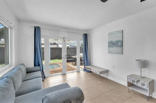 a living room with furniture gym equipment and view of living room