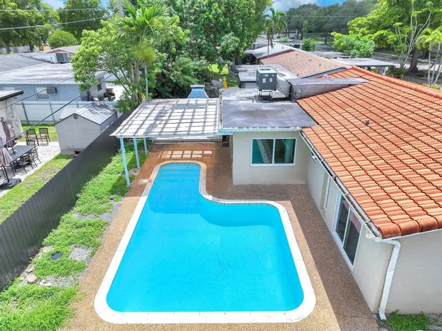 a view of swimming pool with outdoor seating and plants