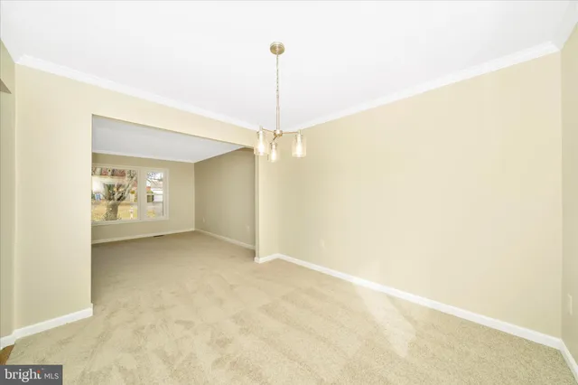 a kitchen with stainless steel appliances granite countertop a stove top oven a sink dishwasher and white cabinets with wooden floor