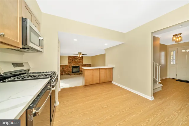 a kitchen with stainless steel appliances granite countertop a refrigerator sink and cabinets