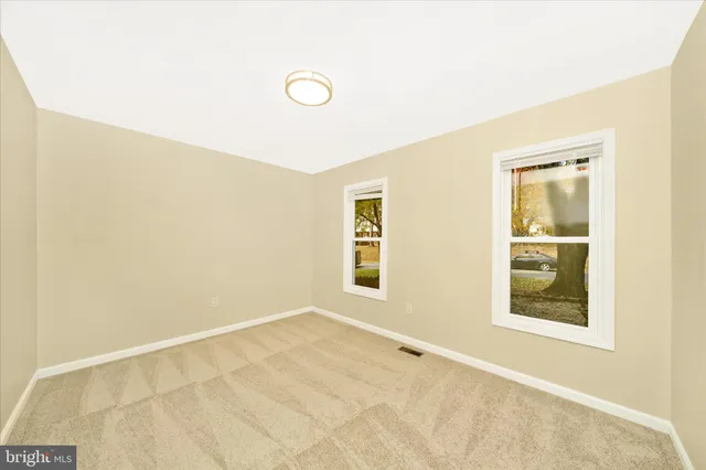 a bathroom with a granite countertop toilet sink and a mirror