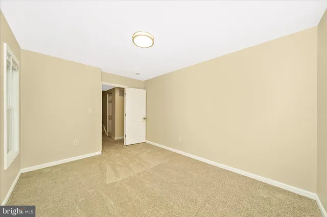 a view of an empty room with a ceiling fan
