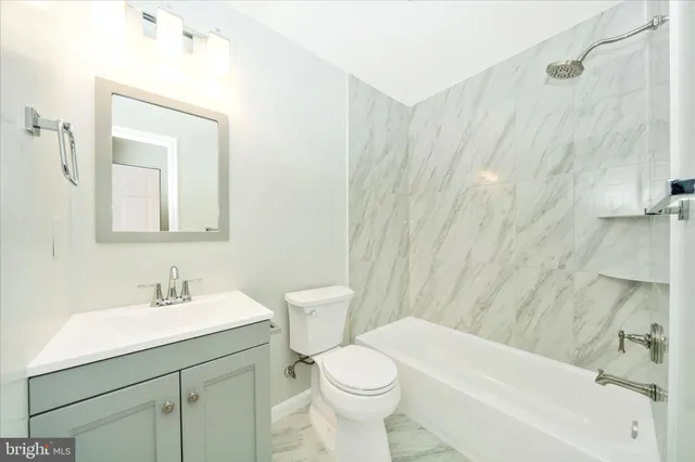 a bathroom with a shower and a sink