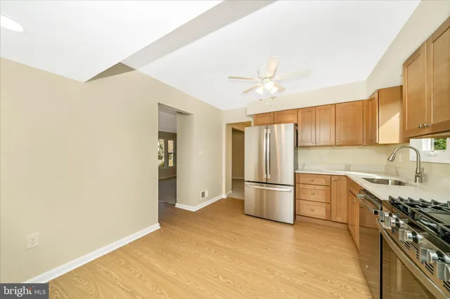 a kitchen with stainless steel appliances granite countertop a refrigerator and a sink