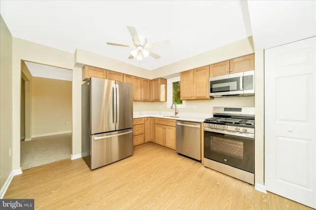 a kitchen with a refrigerator sink and stove
