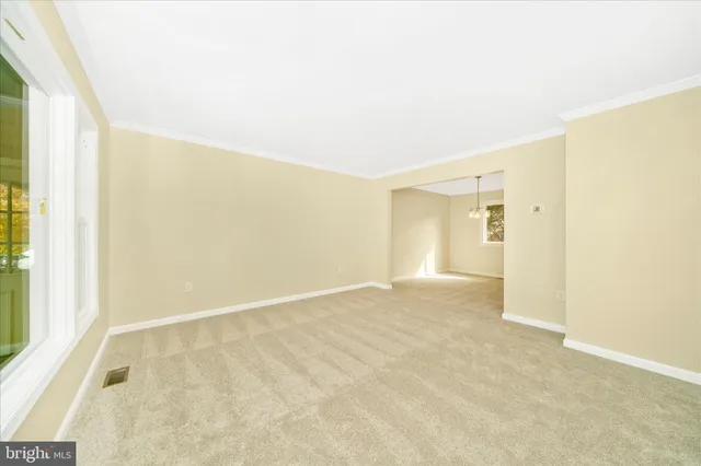 a view of a room with a ceiling fan and window