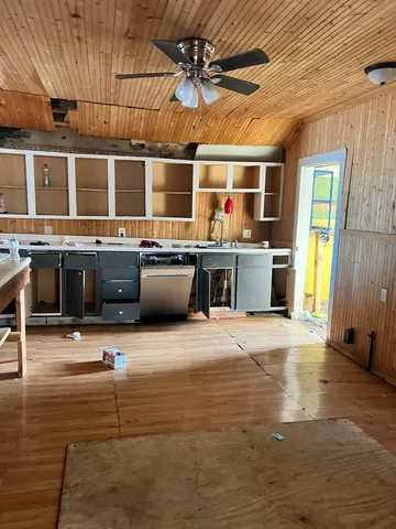 a large kitchen with stainless steel appliances granite countertop a sink and a stove