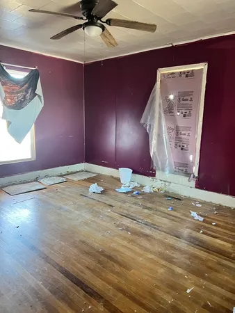 a view of an empty room with a fan