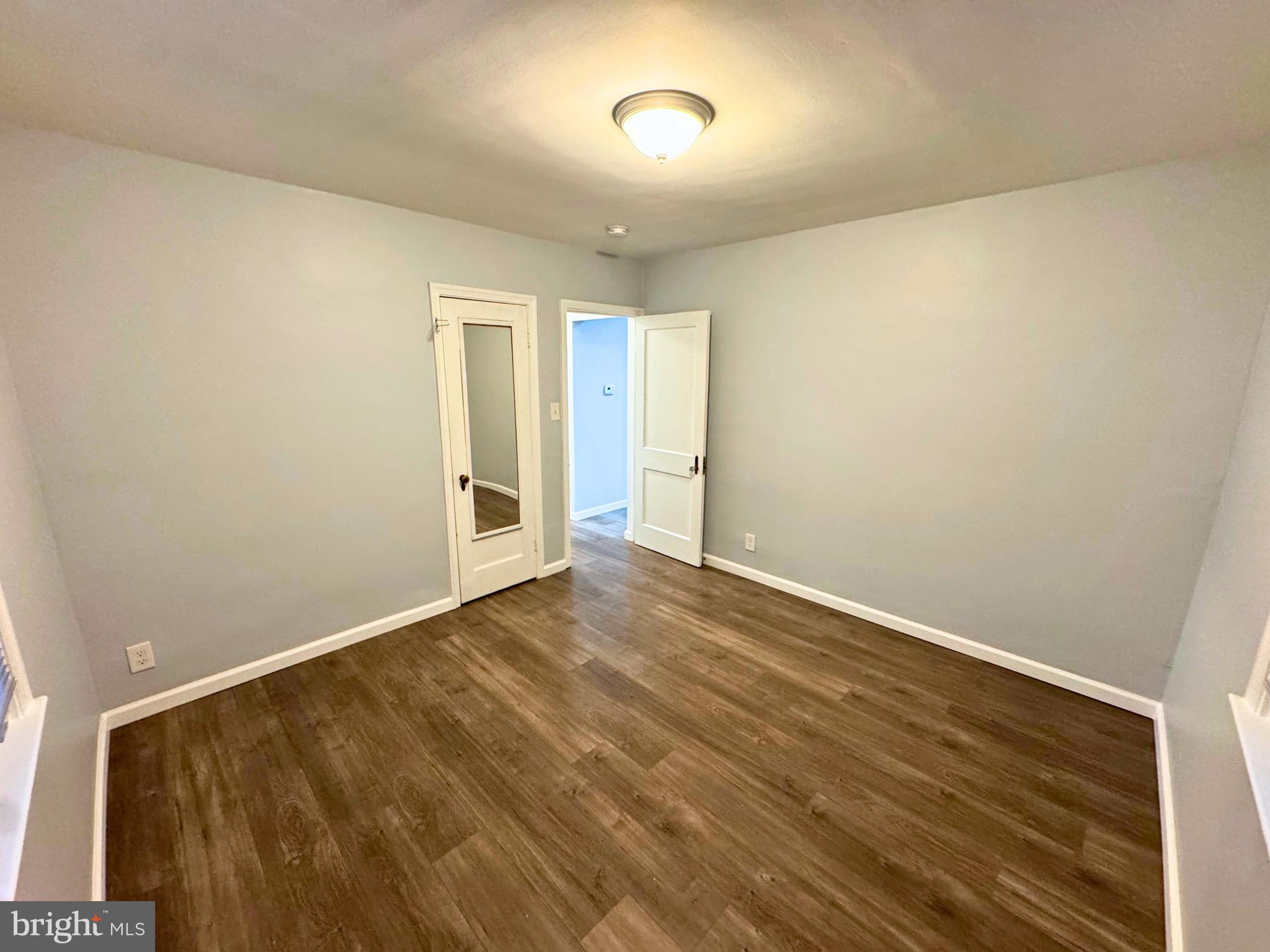 2909 Duncan Lane Parkville, MD 21234 - Photo 11 of 20 an empty room with wooden floor and windows