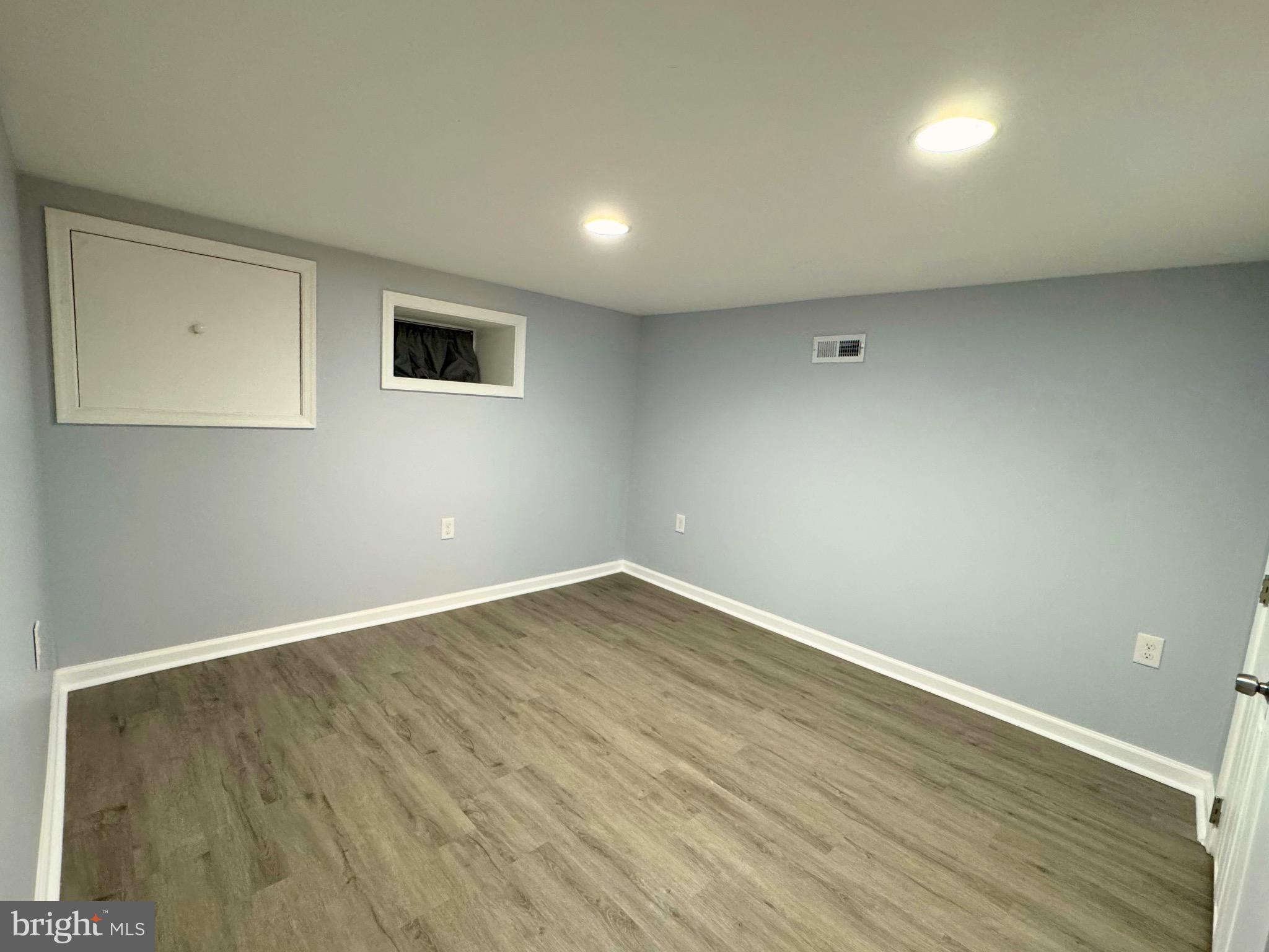 2909 Duncan Lane Parkville, MD 21234 - Photo 17 of 20 an empty room with wooden floor and windows