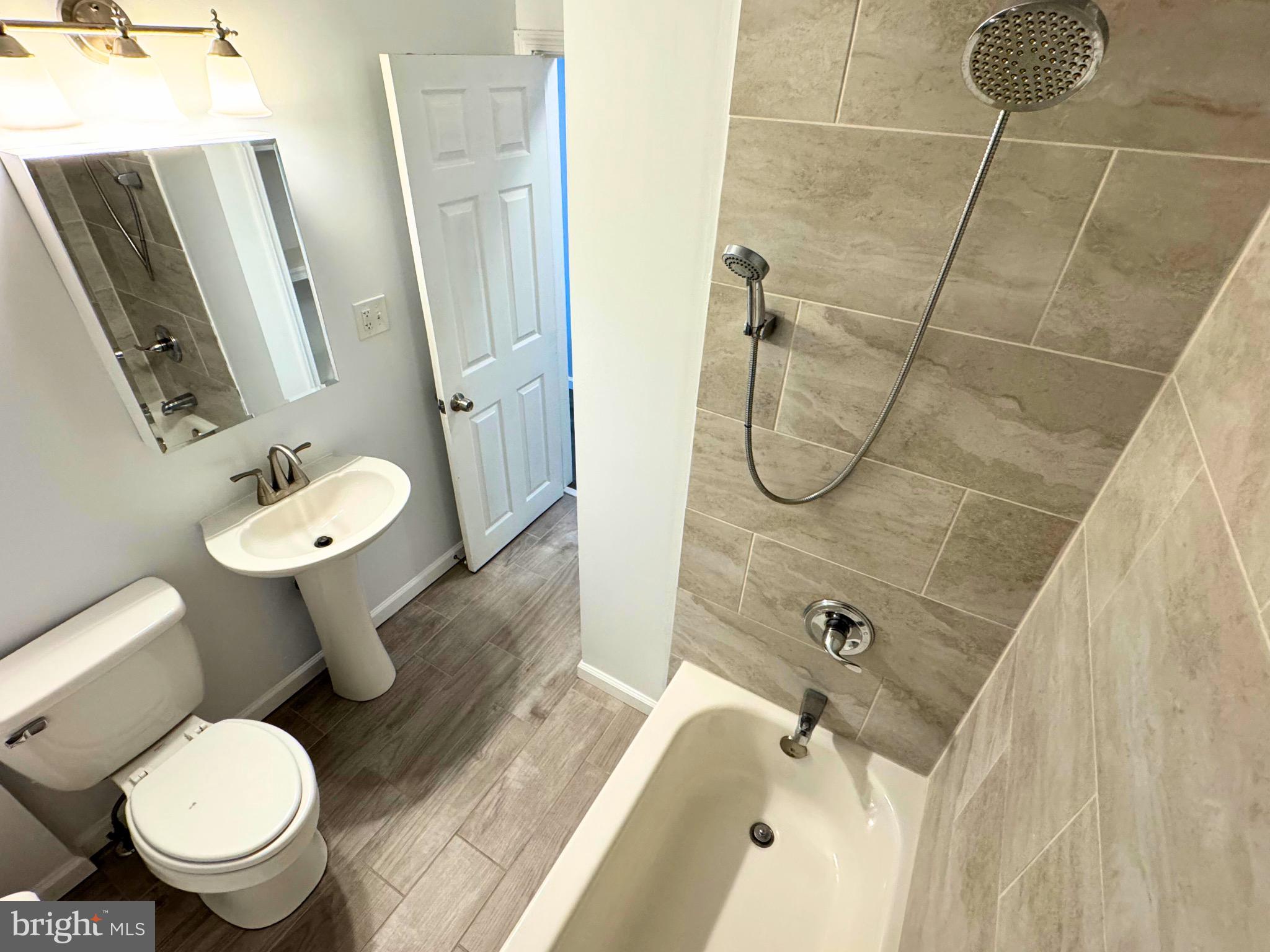 2909 Duncan Lane Parkville, MD 21234 - Photo 9 of 20 a bathroom with a granite countertop toilet a sink and mirror
