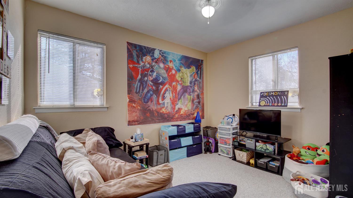 159 Newbury Road Howell, NJ 07731 - Photo 16 of 28 a living room with furniture and a flat screen tv