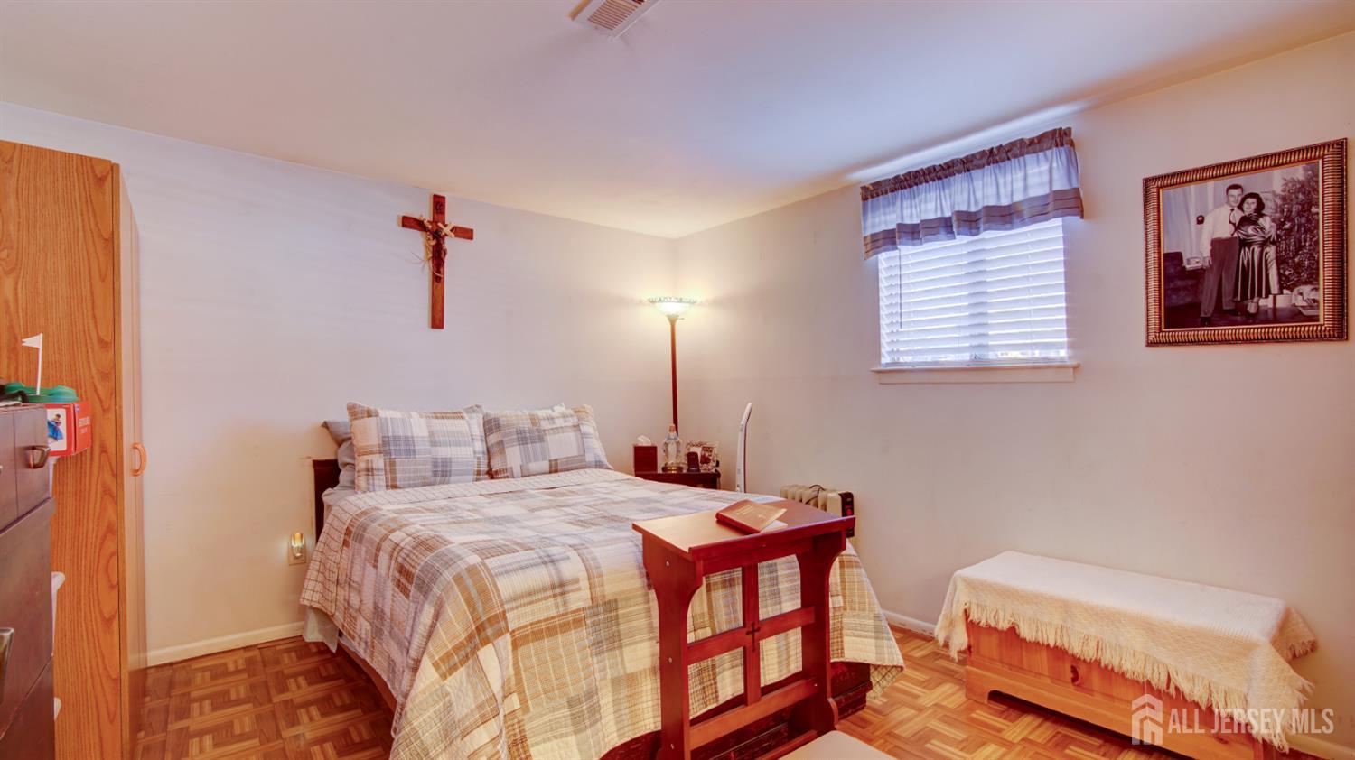 159 Newbury Road Howell, NJ 07731 - Photo 22 of 28 a bedroom with a bed and a chandelier