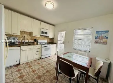 a kitchen with a sink cabinets and window