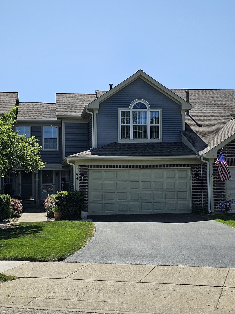 1154 Coldspring Road Elgin, IL 60120 - Photo 1 of 1 a front view of a house with a yard and garage